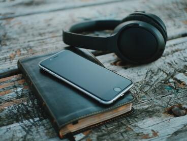 Photo of Bible, phone and headphones
